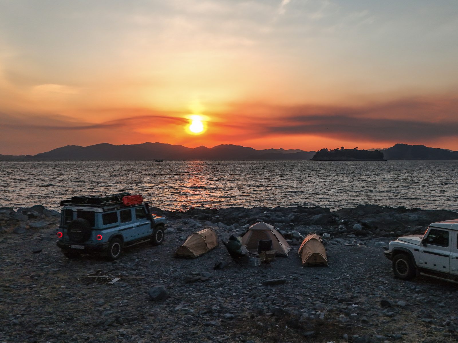Sunset shoreline camp scene