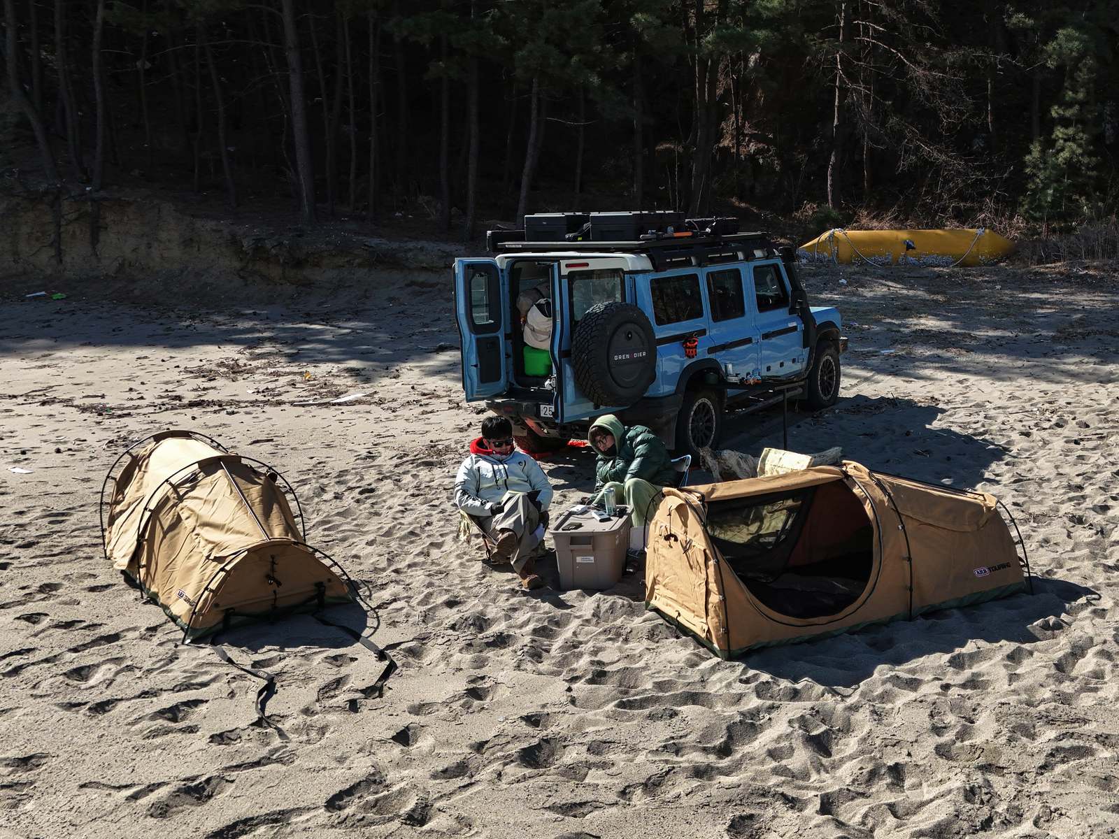 Night-ready camp setup on sand